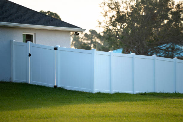 White plastic fence for back yard protection and privacy.