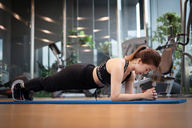 A woman using a Body Exercise App to workout