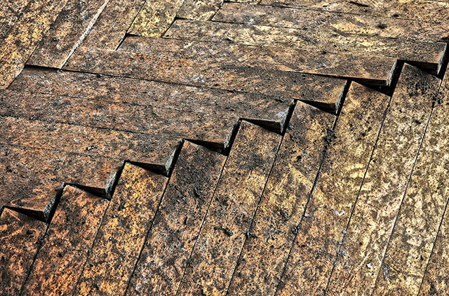 Flooring that has buckled show the Dangers of Discount Flooring