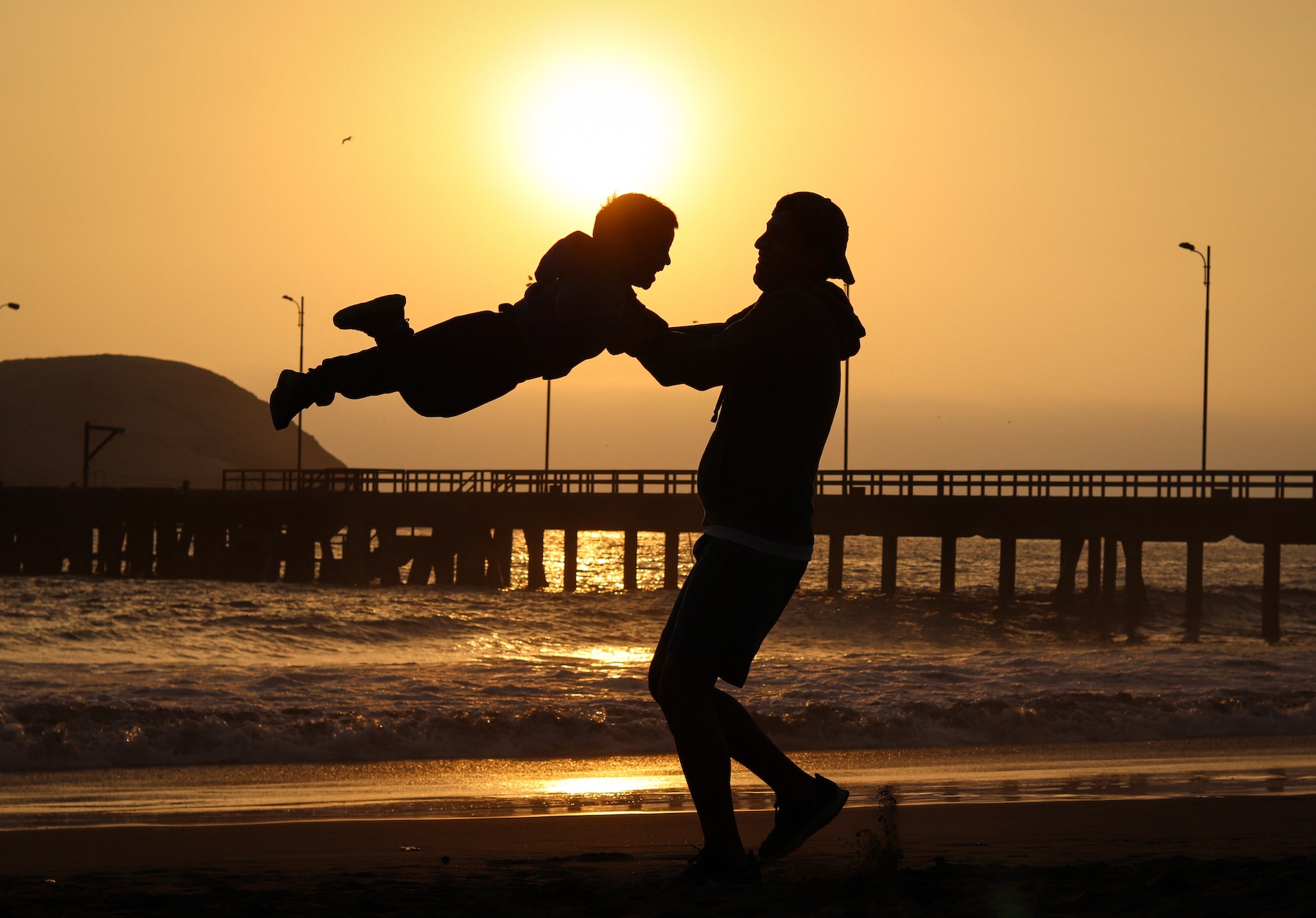 a father playing with his son on the beach