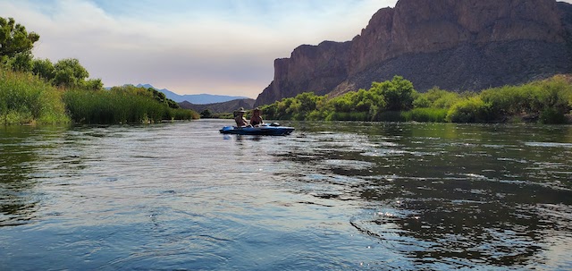 two people kayaking down the river on a first date