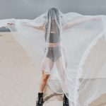 A woman hiding under a Mosquito net