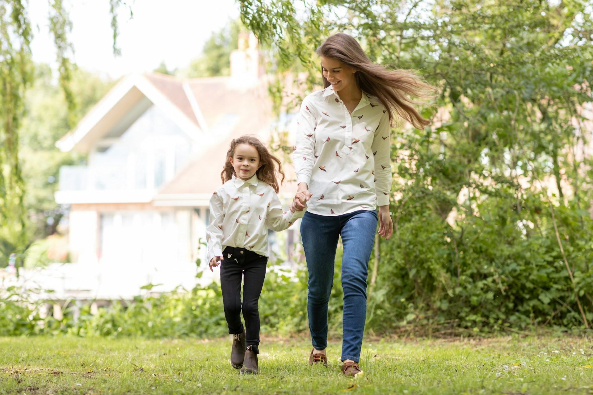 A Mother walking with her daughter in an Environmentally Friendly yard