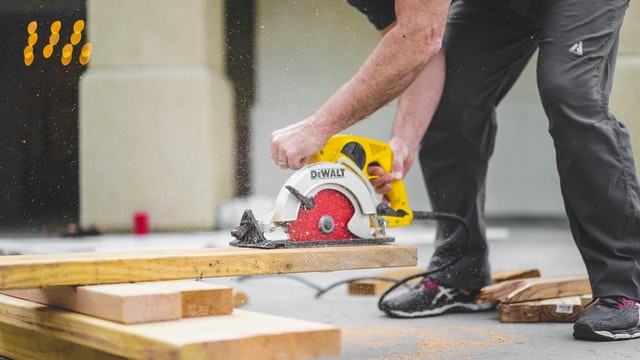 A construction guy with a saw refurbishing a Luxury Home