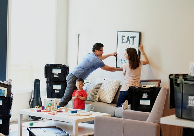 Asian couple and child moving in to new home