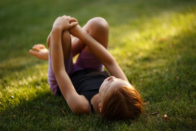 Little girl on grass full of Centipedes