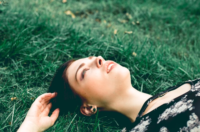 Lady lying on gass after pest control get rid of unwanted pest.