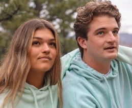 two people wearing hoodies